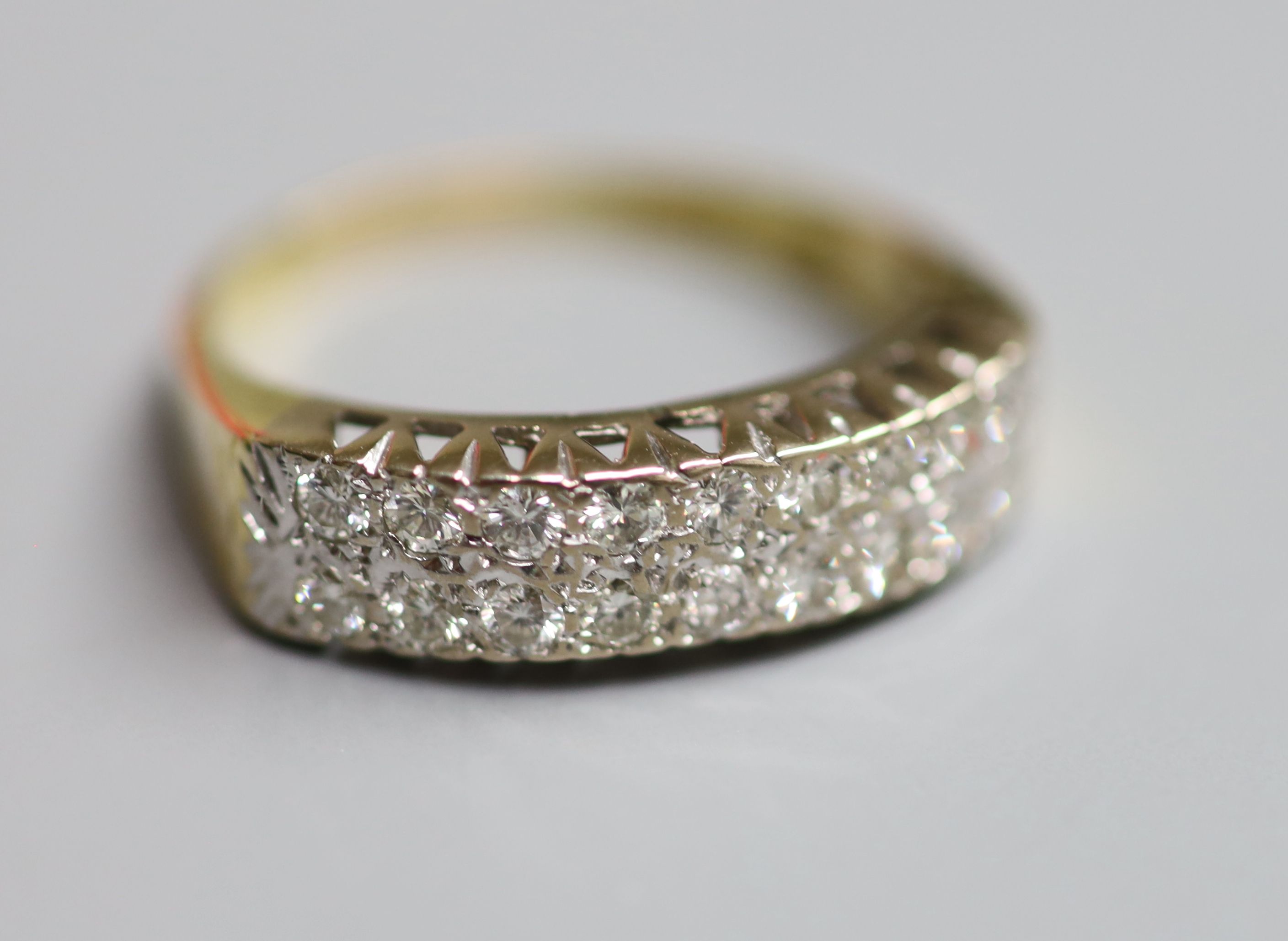 A modern 18ct gold and two row eighteen stone diamond set half eternity ring, size P/Q, gross 5.4 grams.